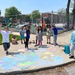 Forest Park Elementary Student Pose for Picture while decorating a storm drain